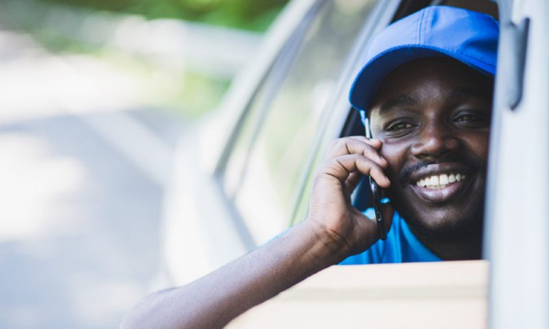 Pathteq QPL courier driver taking a call from the cab of a delivery vehicle